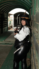 Thick woman dressed in steampunk style inside a freight train car