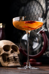 Red hot chili peppers and vodka in glass on table