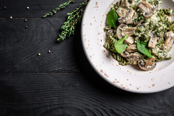 Mushroom and Spinach Pasta in a Bowl, Vegan Food on light background. Vegan or gluten free diet. banner, menu recipe place for text, top view