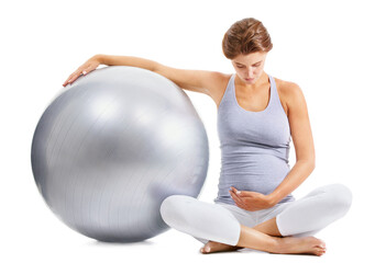 Taking care of her baby before its born. A fit pregnant woman gazing down at her stomach while...