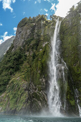 Fototapeta premium Stirling Waterfall in Milford Sound Fiordland National Park in the South Island of New Zealand on a Sunny Day