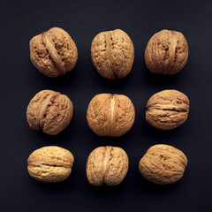 Fresh nuts in hard skin, black background concept ..   