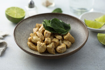 Baked chicken meat with spinach and lime