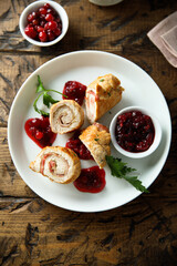 Fototapeta na wymiar Homemade chicken rolls with cranberry sauce