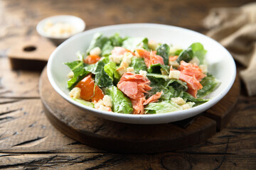 Traditional Caesar salad with salmon