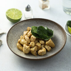 Baked chicken meat with spinach and lime