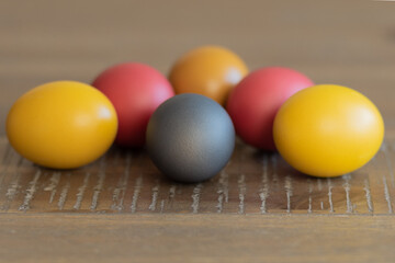 six Easter painted eggs on a wooden background