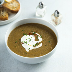 Homemade creamy lentil soup with herbs