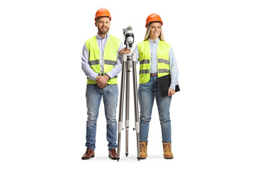 Male and female geodetic surveyors posing with a measuring station