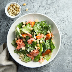 Traditional Caesar salad with salmon