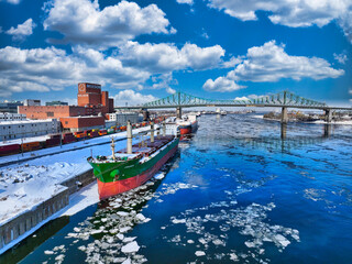 Ship waiting at Montreal Port with Jacques Cartier Bridge in background - obrazy, fototapety, plakaty