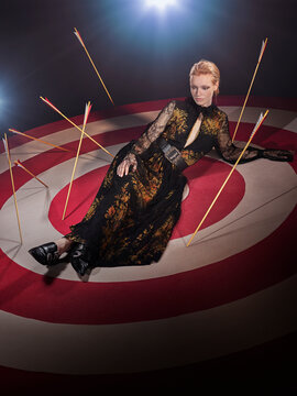 Portrait Of A Redhead Woman On Large Hand Painted Bulls-eye Target With Arrows