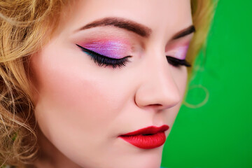 Beautiful woman with red lipstick. Closeup face of girl with healthy clean skin and bright makeup. Closed eyes.