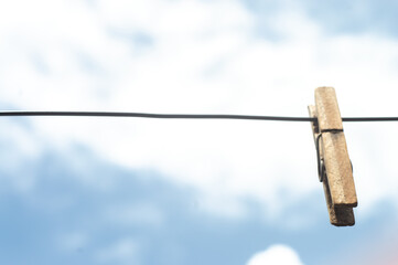 Clothesline fastener on a clothesline with no clothes and blue sky in the background