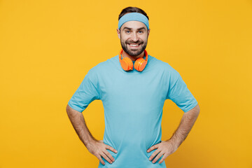 Young fitness trainer instructor sporty man sportsman in headband blue t-shirt spend weekend in...