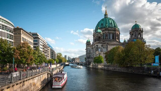 Berlin, Germany, zoom out time lapse view of historic landmark Berlin Cathedral church (Berliner Dom) and tour boats on the Spree River by day in fall season.	
