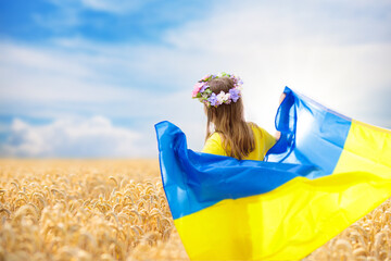 Pray for Ukraine. Child with Ukrainian flag.