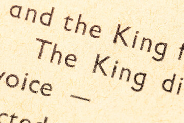 The King, printed word, text in an old antique book, macro, extreme closeup. Royalty, ruler, leader, monarchy symbol, nobility authority abstract concept, nobody, literature story, fable character