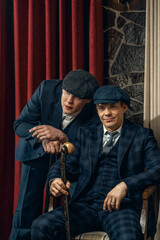 Two men in stylish suits confer,  england in 1920s theme. Peaky blinders style.