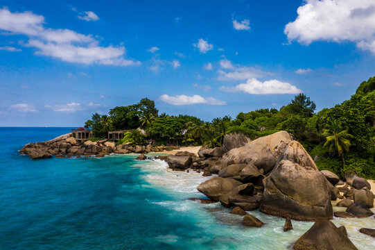 Aerial photo over Seychelles displaying the natural unspoilt beauty of the islands - from the crystal clear oceans to the lush green forests and granite boulders cascading on the white beaches. 