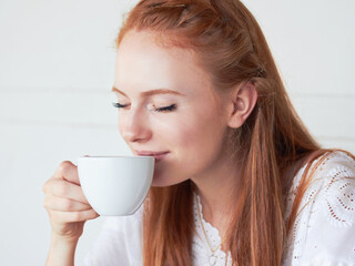Theres nothing like fresh coffee in the morning. Cropped shot of a young woman drinking coffee at a...
