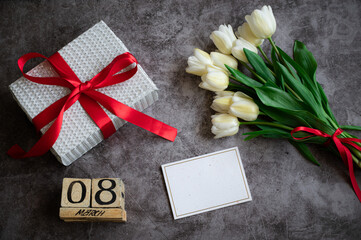 Fototapeta na wymiar Women's day flatlay composition with gift and flowers