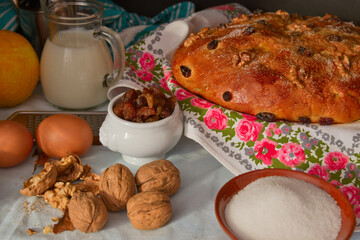 Still life with all the necessary ingredients to cook a walnut and raisin cake