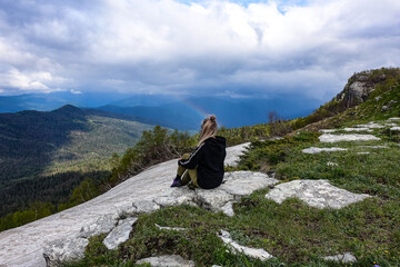 A girl on the background of alpine meadows of the Lago-Naki plateau in Adygea. Russia. 2021.