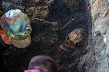 Human skull in the ground. Archaeological excavations of criminologists for examination. Background