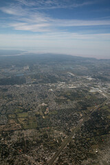 Cityscape. Aerial view of the city from very high. The town buildings, houses, streets and vast extension of land. Urban texture and pattern.