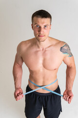Obraz premium Man with weights health pondered, health and sports on a white background pain hurt ill sick caucasian health medicine, muscular expression. Hold neck therapy, ain suffer attractive