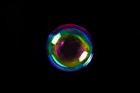 Soap bubble isolated on black background. Copy space.