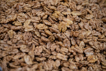 Pile of whole walnut at street market, freshly harvested. Natural background.