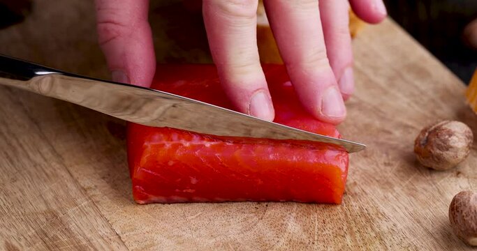 slicing red salted salmon into pieces