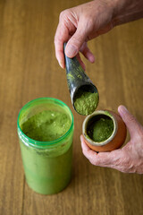 Hands of a man preparing chimarrão, the traditional South American yerba mate drink