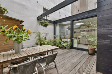 Elegant compact courtyard of the house with greenery and panoramic windows