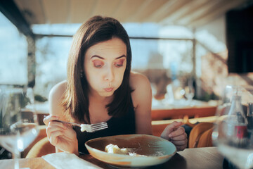 Woman Eating in a Restaurant Blowing in Hot Meal