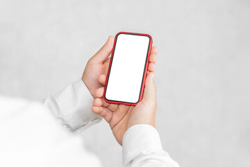 Mockup of a red smartphone in the hands of a man. On a light background.
