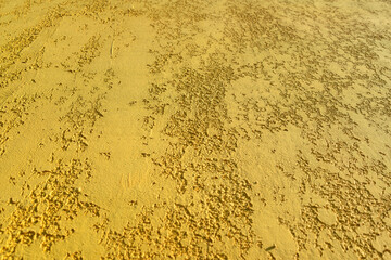 Close-up, the texture of the facade of decorative yellow plaster.