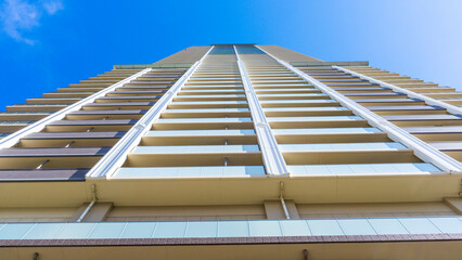 Exterior of high-rise condominium and refreshing blue sky scenery_w_53
