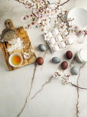 Easter culinary background. Easter food ingredients composition on the kitchen table and copy space for a text menu or recipe