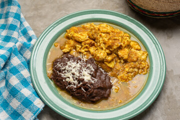 Scrambled eggs with red sauce and beans. Mexican food