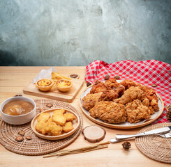 Fried chicken egg tart and french fries in wooden plate on wooden background, Deep fried Chicken and nuggets on wooden table