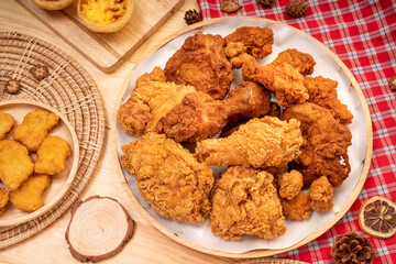 Fried chicken in wooden plate on wooden background, Deep fried Chicken on wooden table.