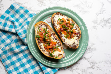 Molletes with fresh sauce and cheese. Mexican food