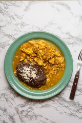 Scrambled eggs with red sauce and beans. Mexican food