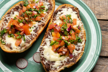 Molletes with fresh sauce and cheese. Mexican food