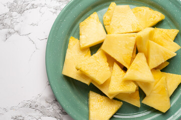 Cutted pineapple fruit on marble background