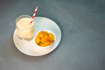 Yellow Indian mango yoghurt drink Mango Lassi or smoothie with turmeric and saffron.