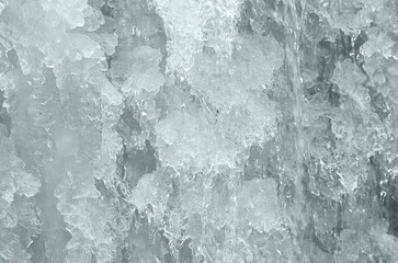 Fototapeta na wymiar Frozen water in fountain. ice waterfall. Winter background.
